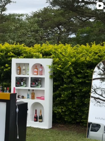 Mobile bar cart set against greenery